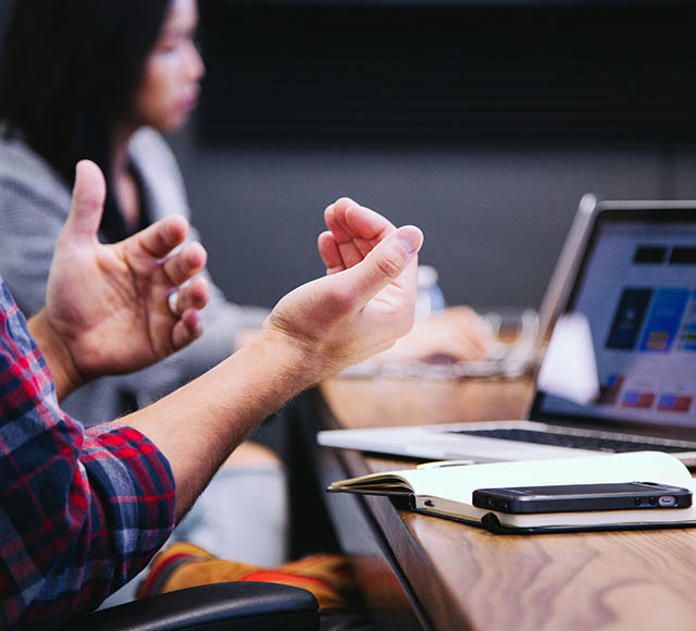 Photo of people talking around a table