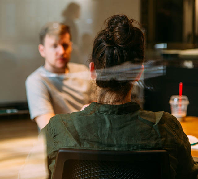 Photo of people talking around a tablep