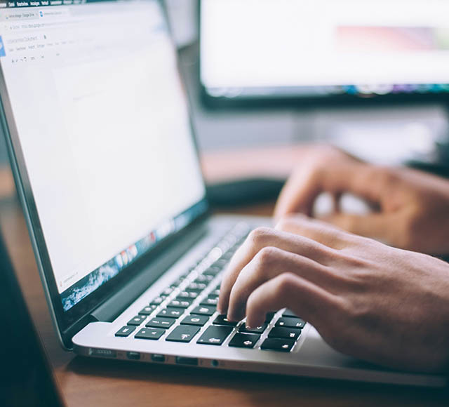 Photo of a person working on a laptop
